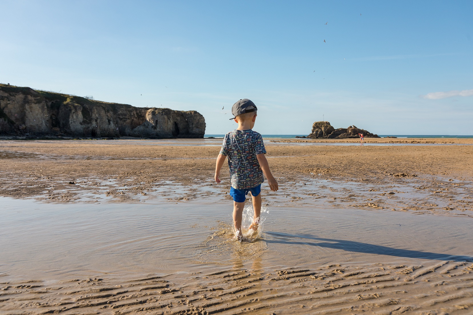 Child paddling on the beach in Perranporth