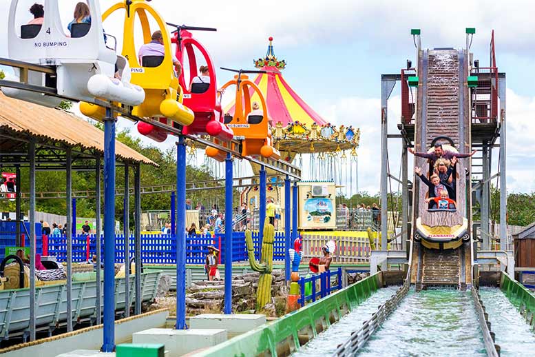 People coming down a log flume at Flambards