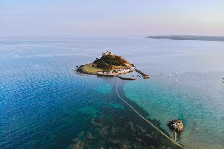 A bird's eye view of St Michael's Mount surrounded by the sea in Cornwall